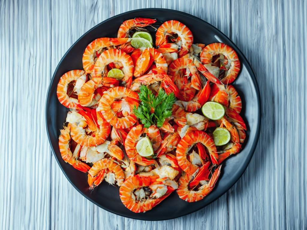 Fresh seafood Essaouira A plate of cooked prawns garnished with lime wedges and fresh parsley.