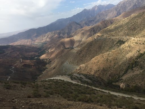 Mountainous landscape with rugged terrain and winding river in a valley.
